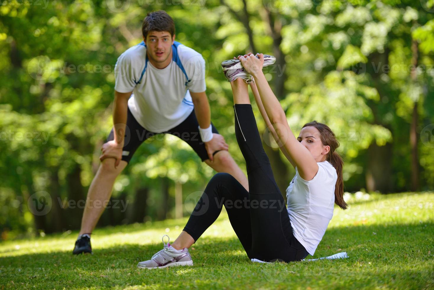 Couple doing stretching exercise  after jogging photo
