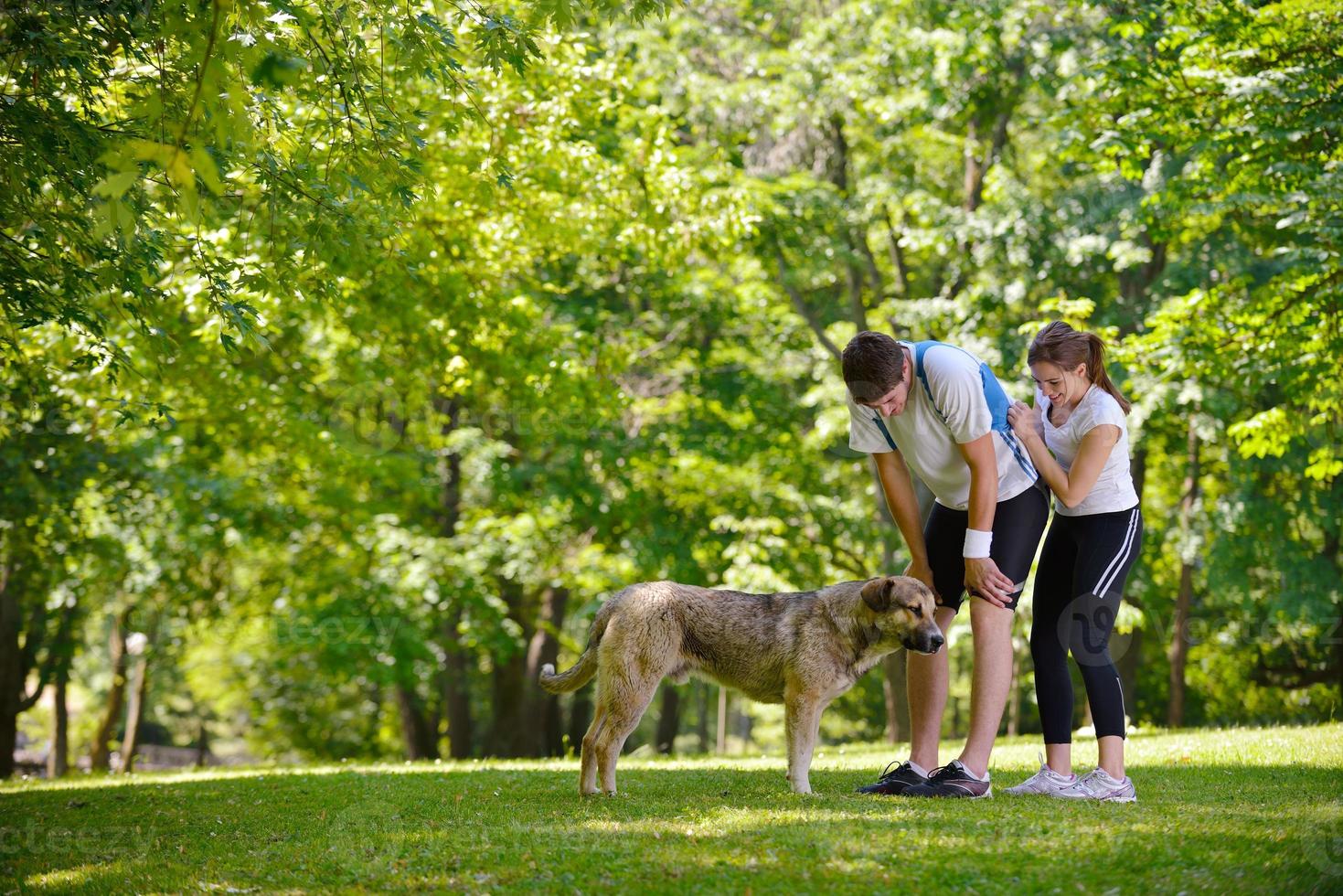 Couple doing stretching exercise  after jogging photo