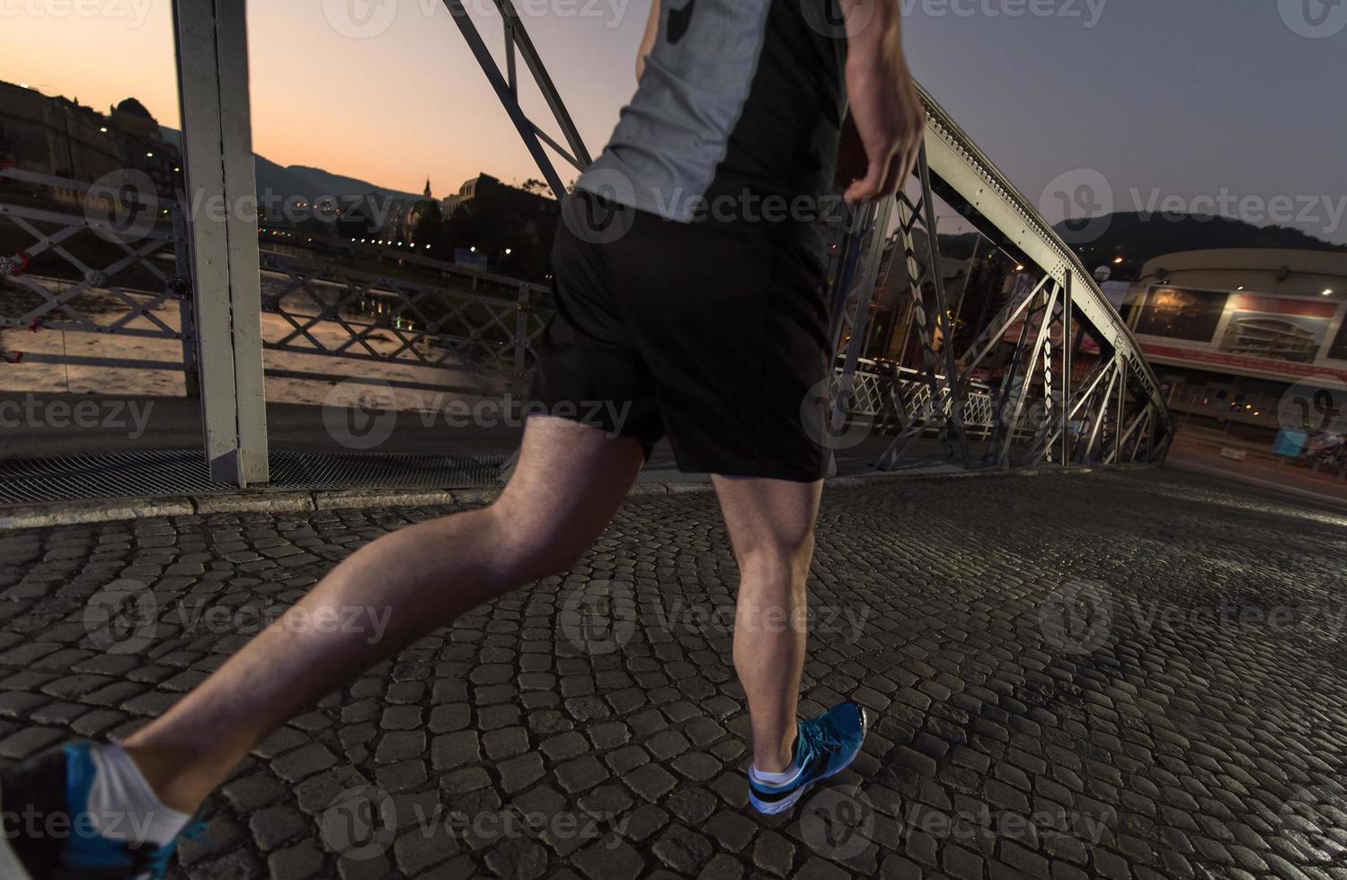 man jogging across the bridge in the city photo