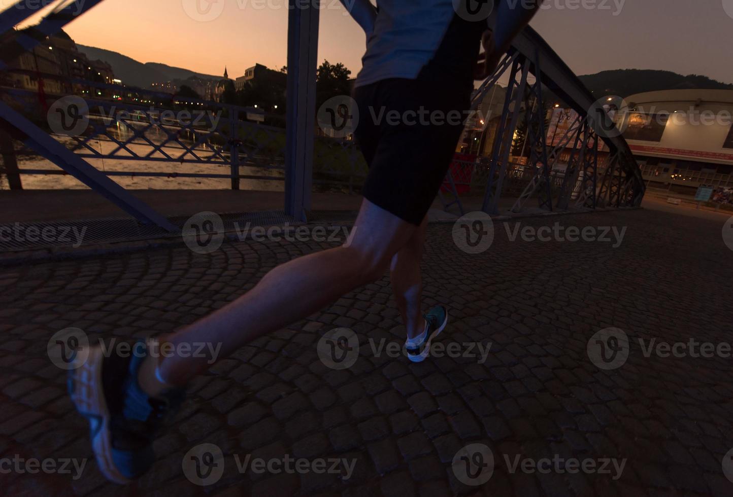 man jogging across the bridge in the city photo
