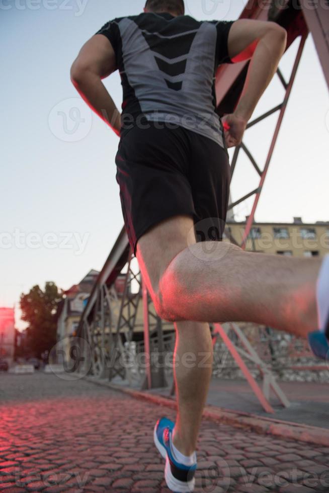 man jogging across the bridge at sunny morning photo