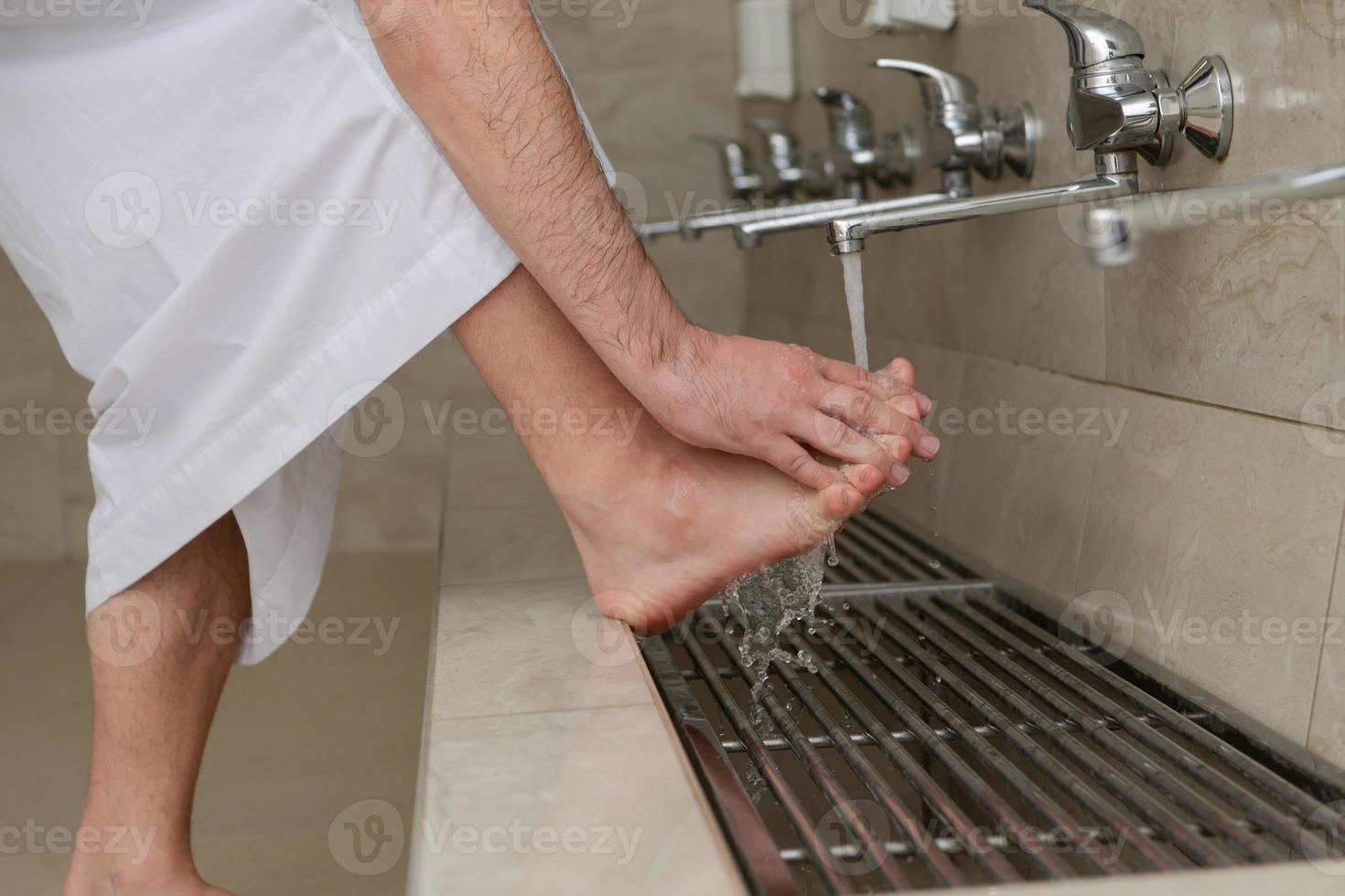 A Muslim takes ablution for prayer. Islamic religious rite photo