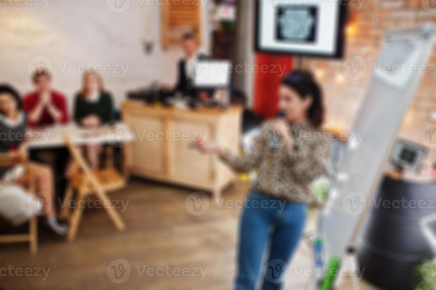 Master class and study concept. Abstract blurred photo of conference or seminar room with speaker on the stage.