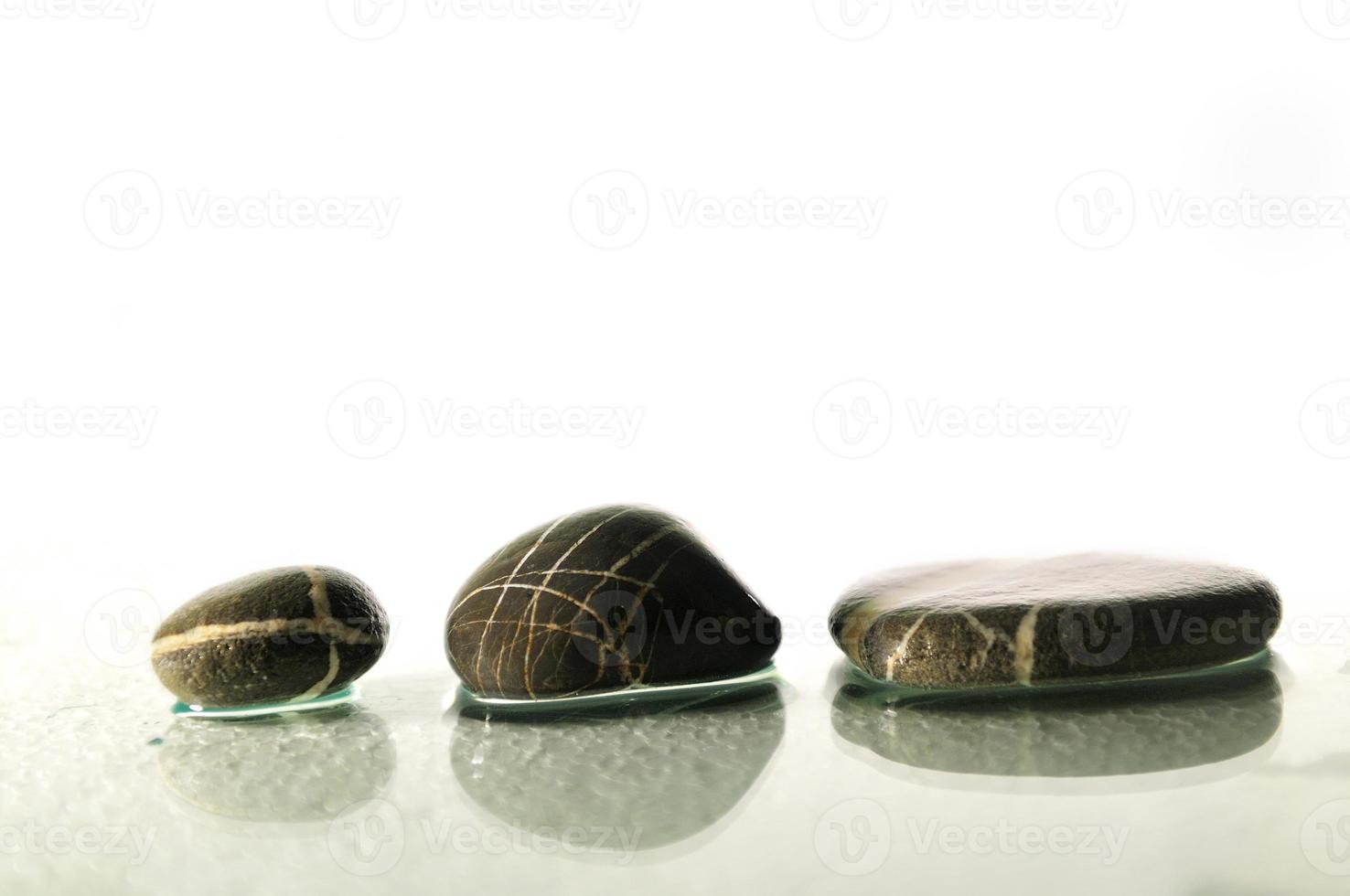 isolated wet zen stones with splashing  water drops photo