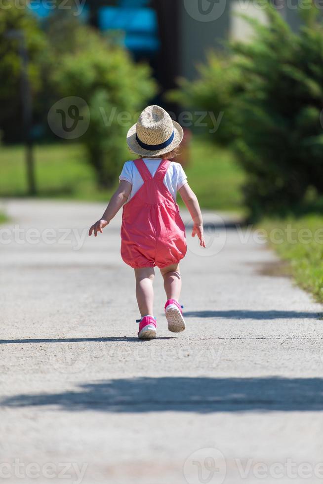 little girl runing in the summer Park photo