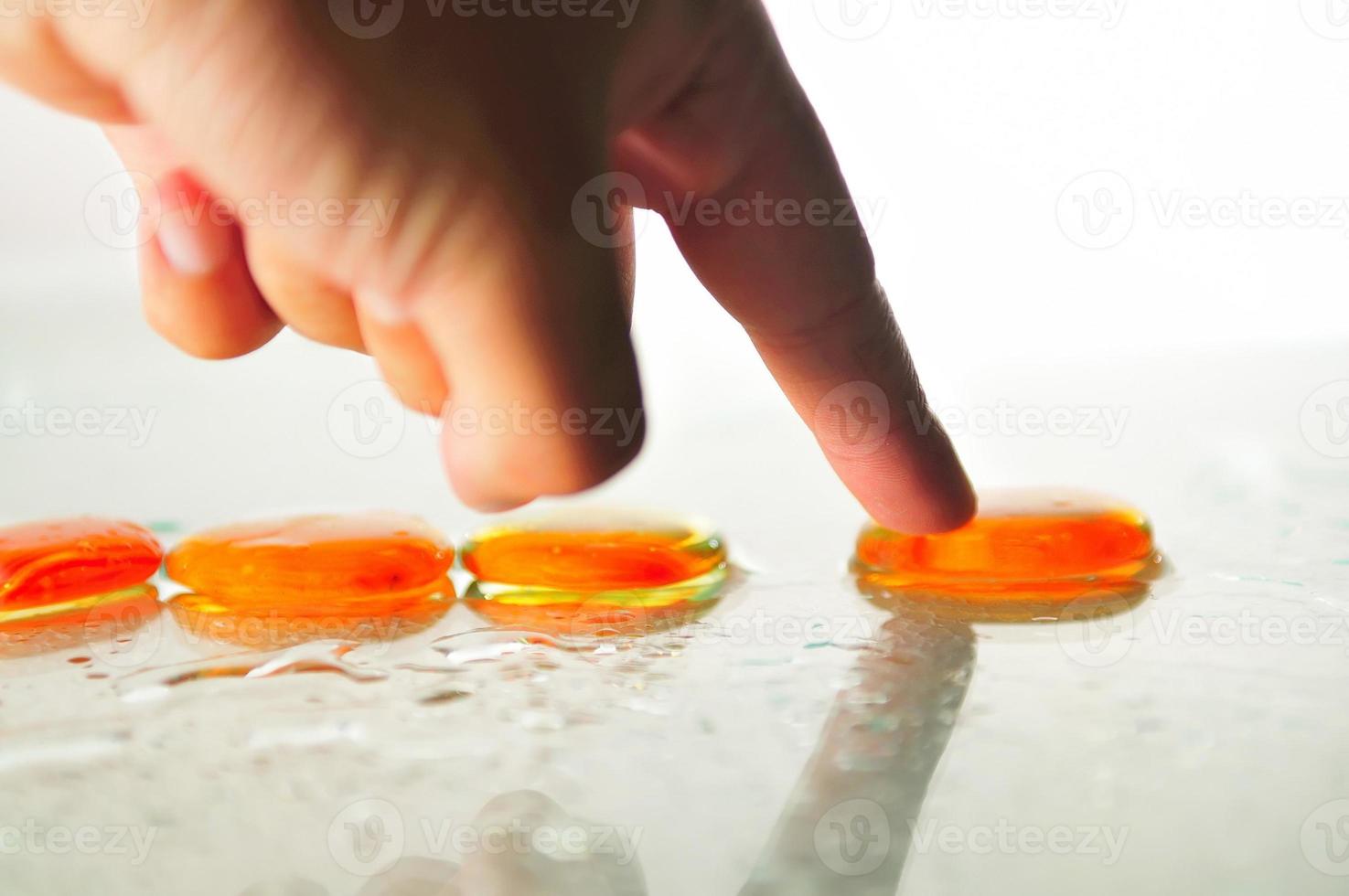 Picture of Man holding finger on zen stone photo