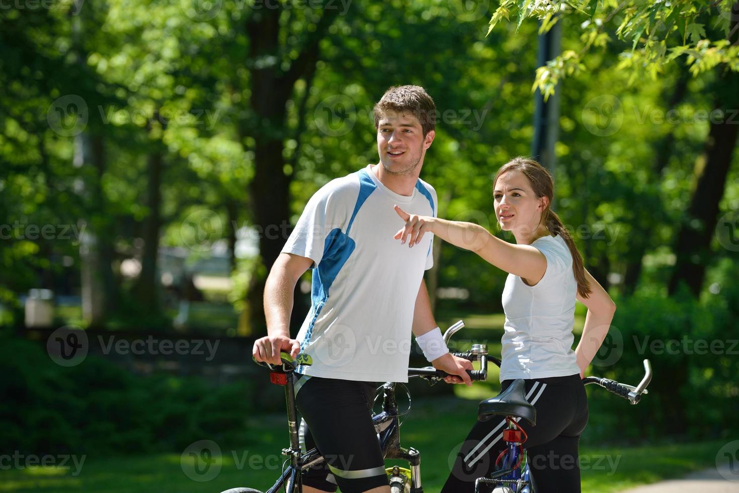 Happy couple riding bicycle outdoors photo