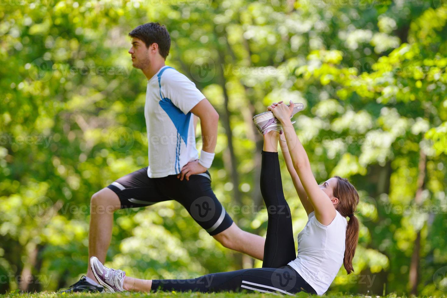 Couple doing stretching exercise  after jogging photo
