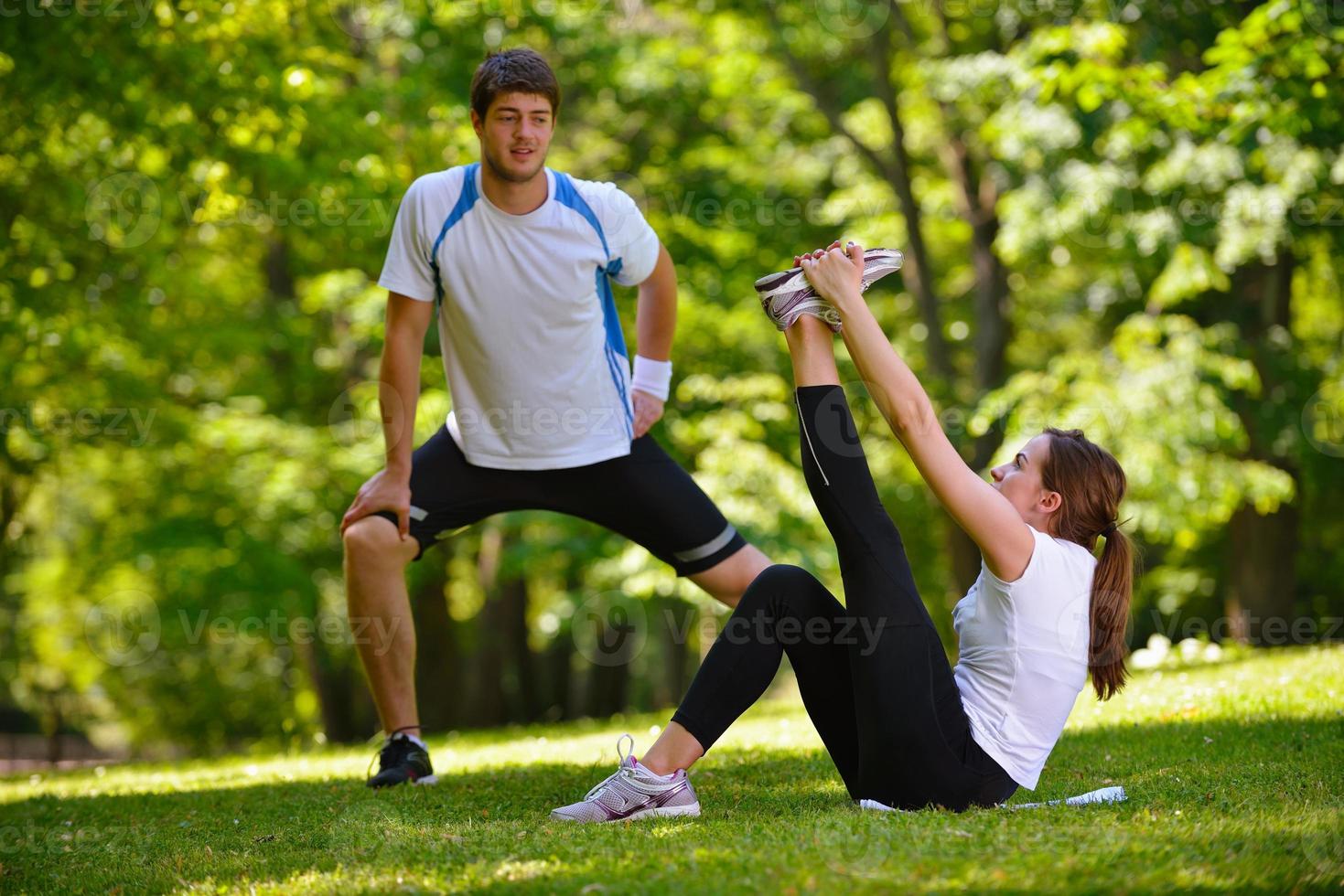 Couple doing stretching exercise  after jogging photo
