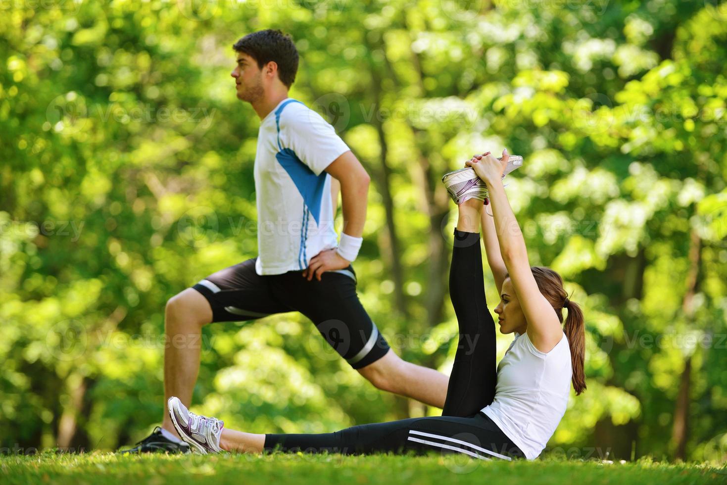 Couple doing stretching exercise  after jogging photo