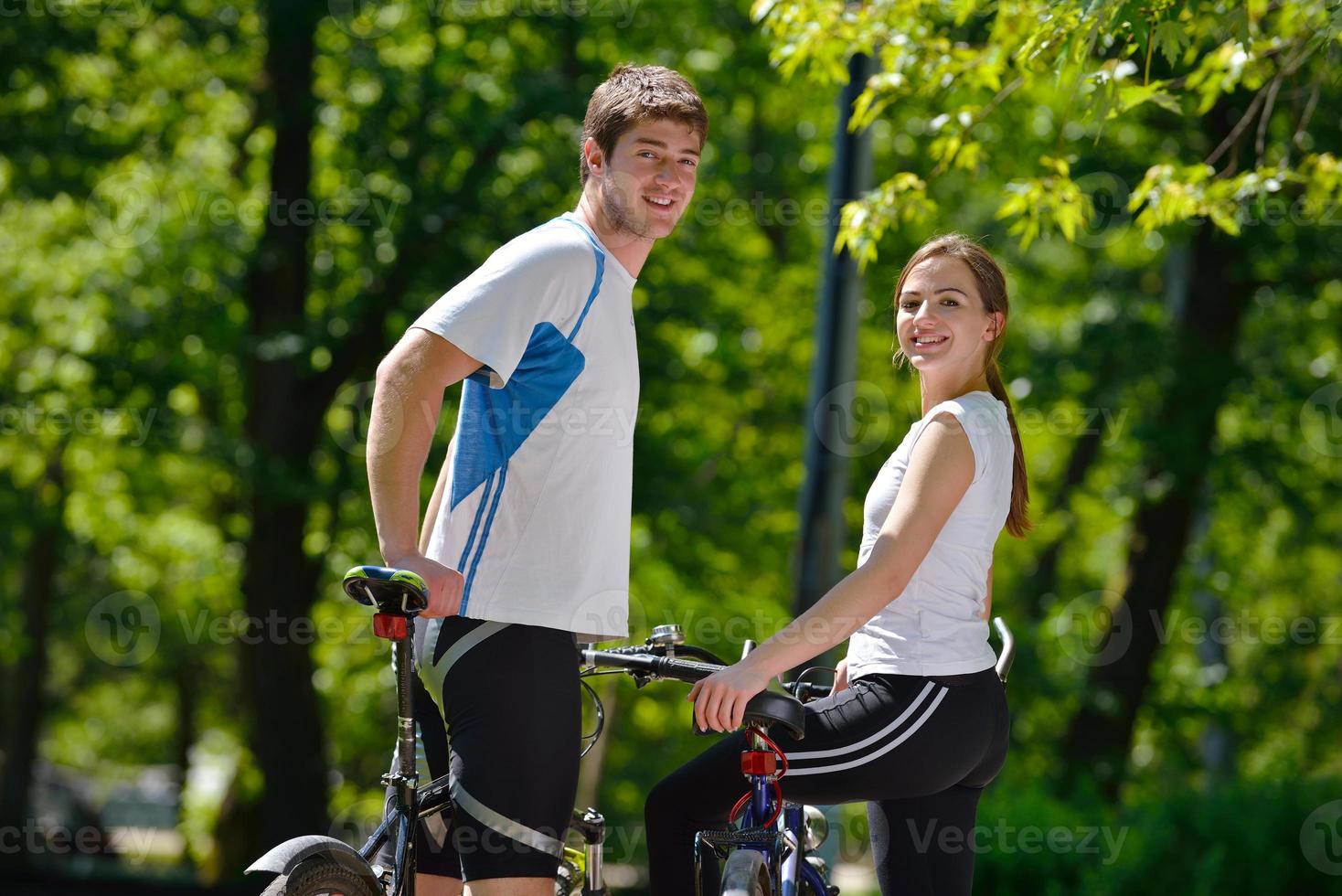 Happy couple riding bicycle outdoors photo