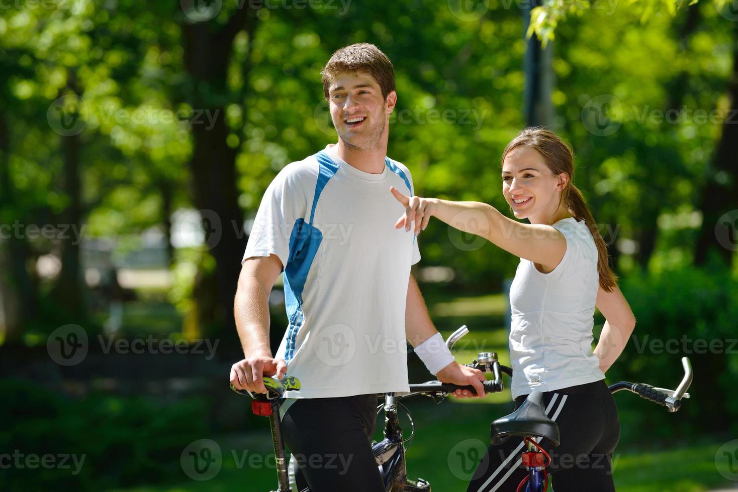 Happy couple riding bicycle outdoors photo