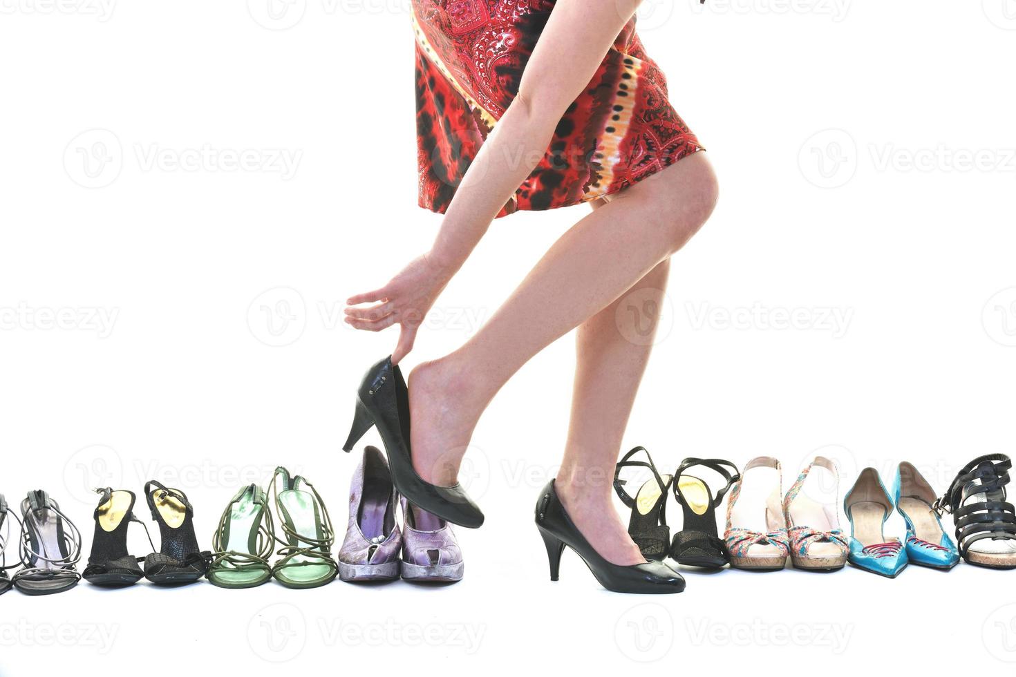 pretty young woman with buying shoes addiction, isolated on white background photo