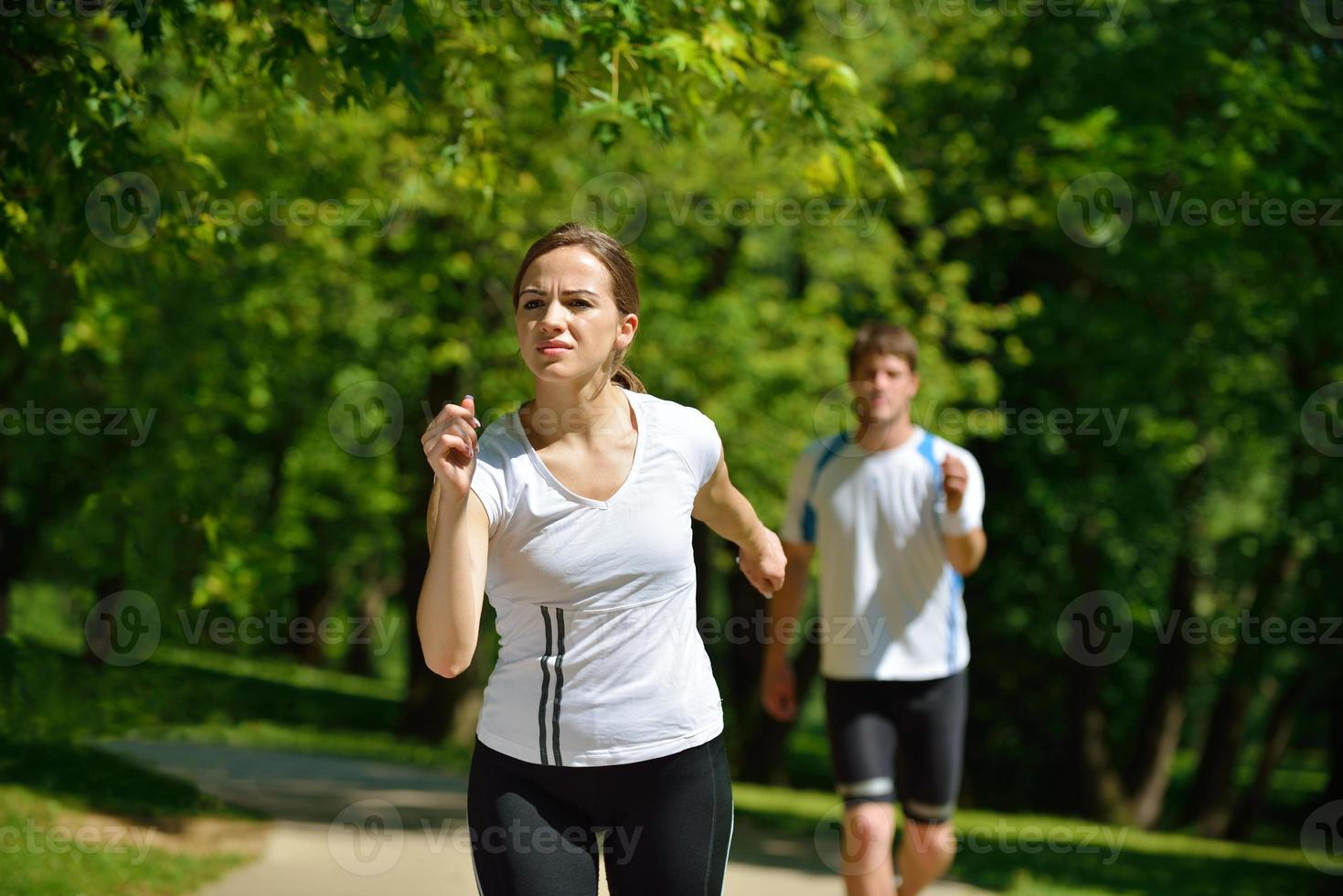 Young couple jogging at morning photo