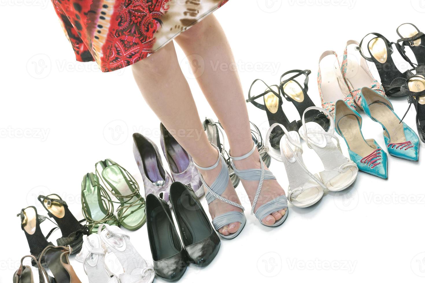 pretty young woman with buying shoes addiction, isolated on white background photo