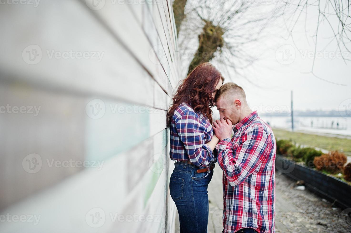 Stylish couple wear on checkered shirt in love together. photo