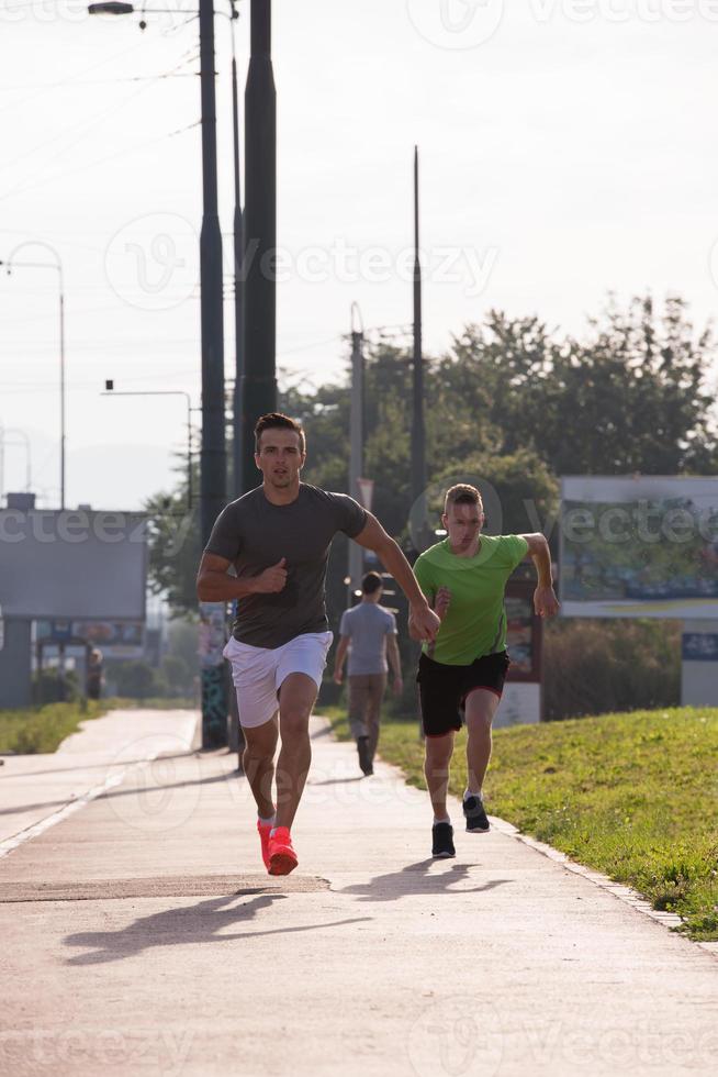 Two young men jogging through the city photo