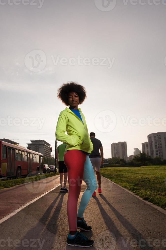 Portrait of sporty young african american woman running outdoors photo