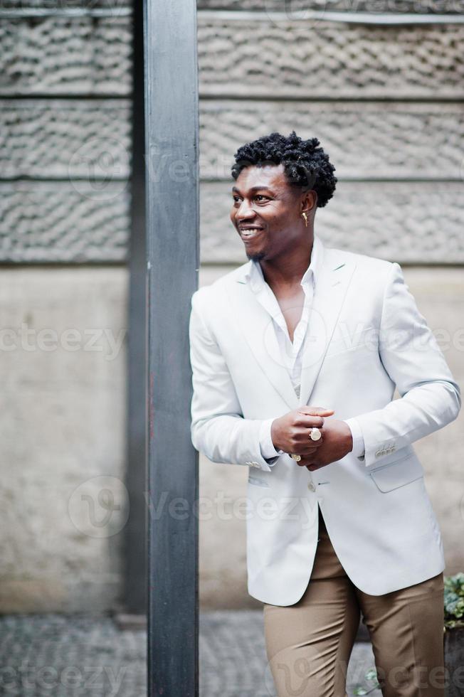 Thoughtful young handsome african american gentleman in formalwear. Black stylish model man in white jacket. photo