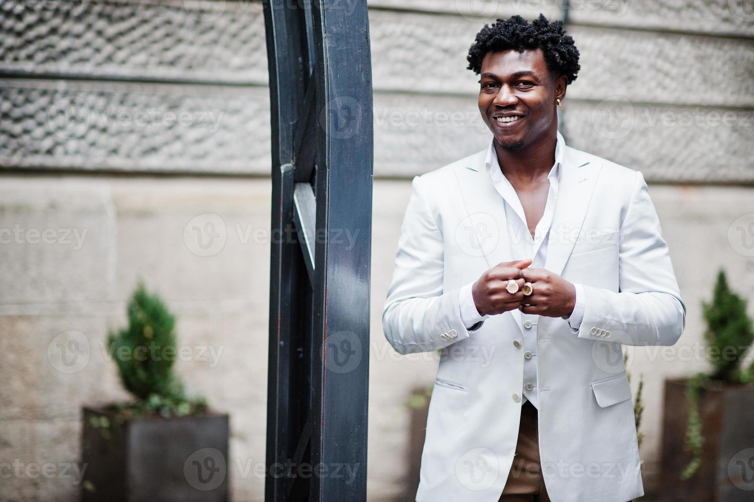 Thoughtful young handsome african american gentleman in formalwear. Black stylish model man in white jacket. photo