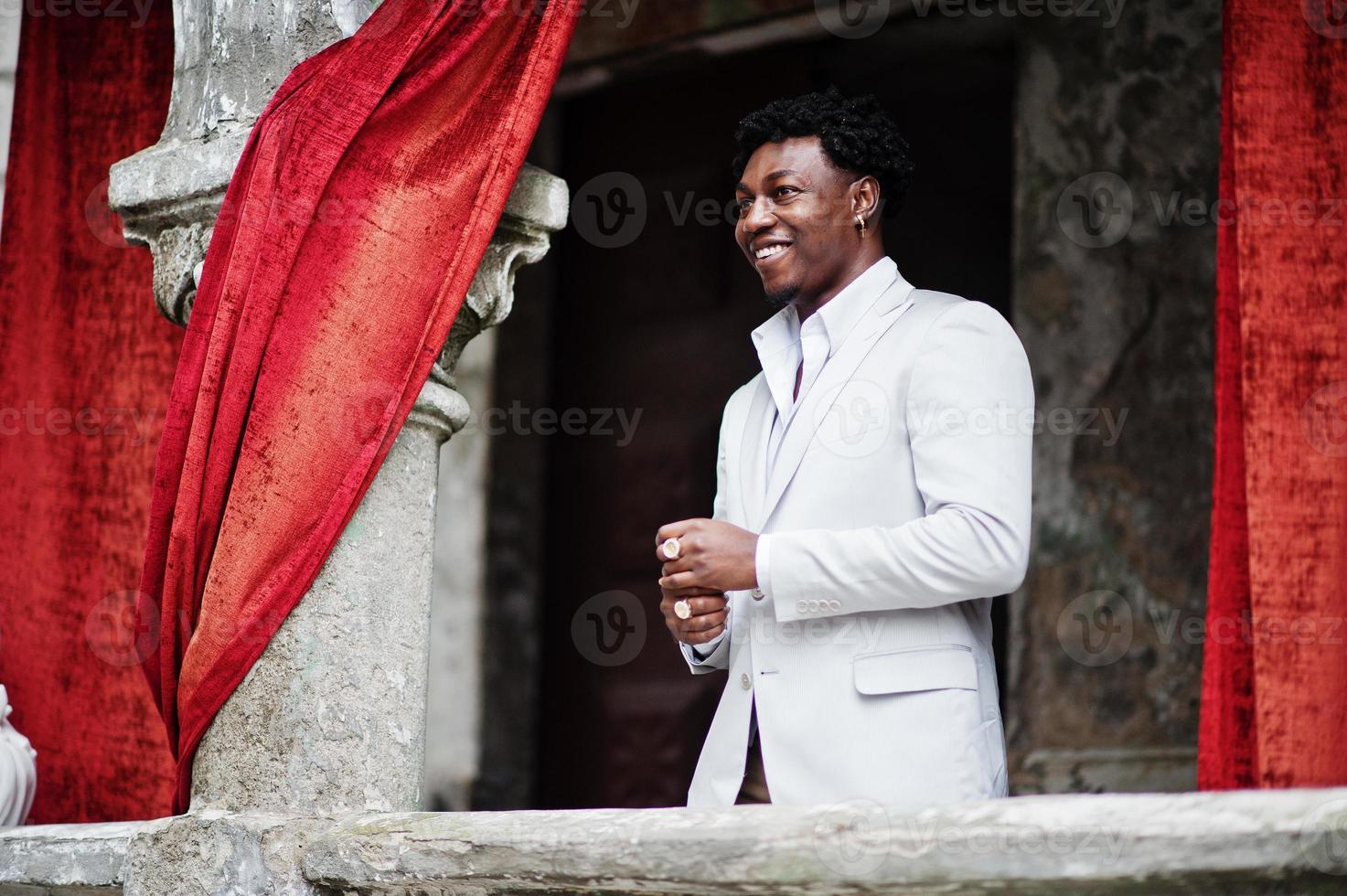 Thoughtful young handsome african american gentleman in formalwear. Black stylish model man in white jacket. photo