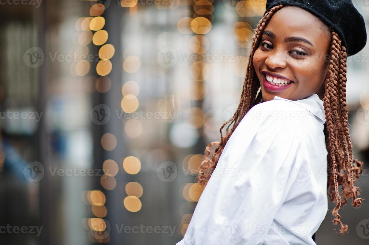 Close up portrait of african american woman in overalls and beret. photo