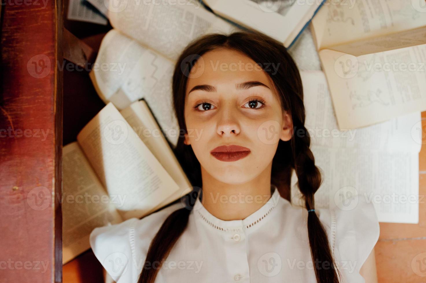 Girl with pigtails in white blouse at old library. photo