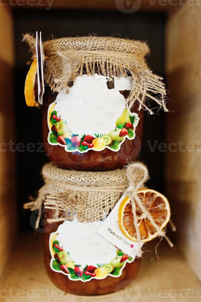 Glass jars with different kinds of jam and berries of a supermarket shelves or grocery store. Homemade canning products. Made with love. photo