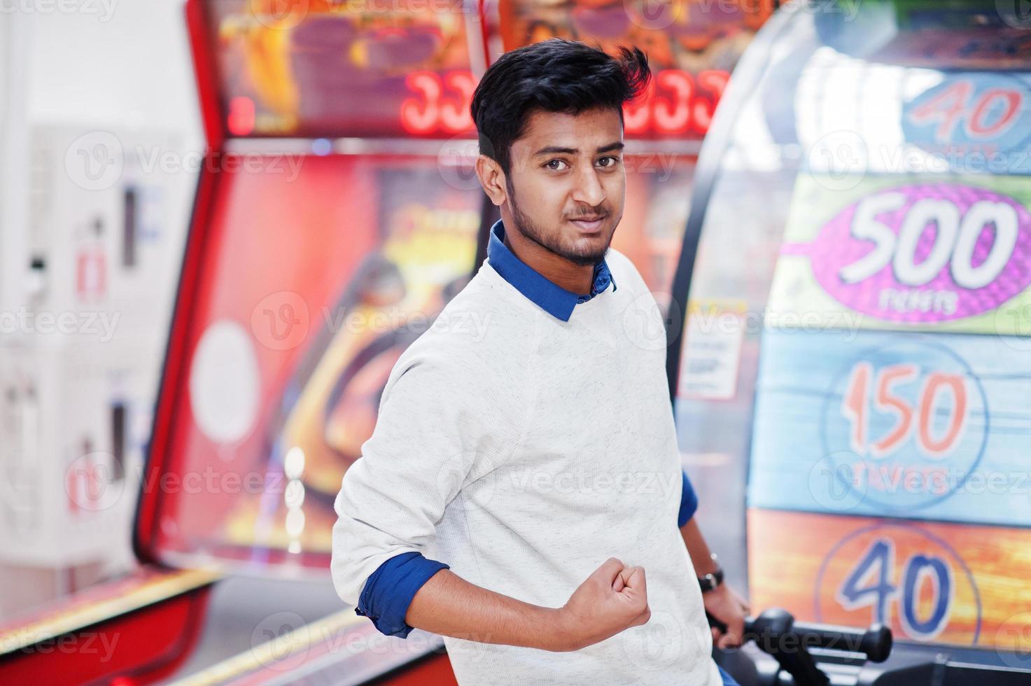 Young asian man play on fortune wheel slot machines to try win at lottery great prize. Gamble jackpot prize spin. Round drum casino money game. photo