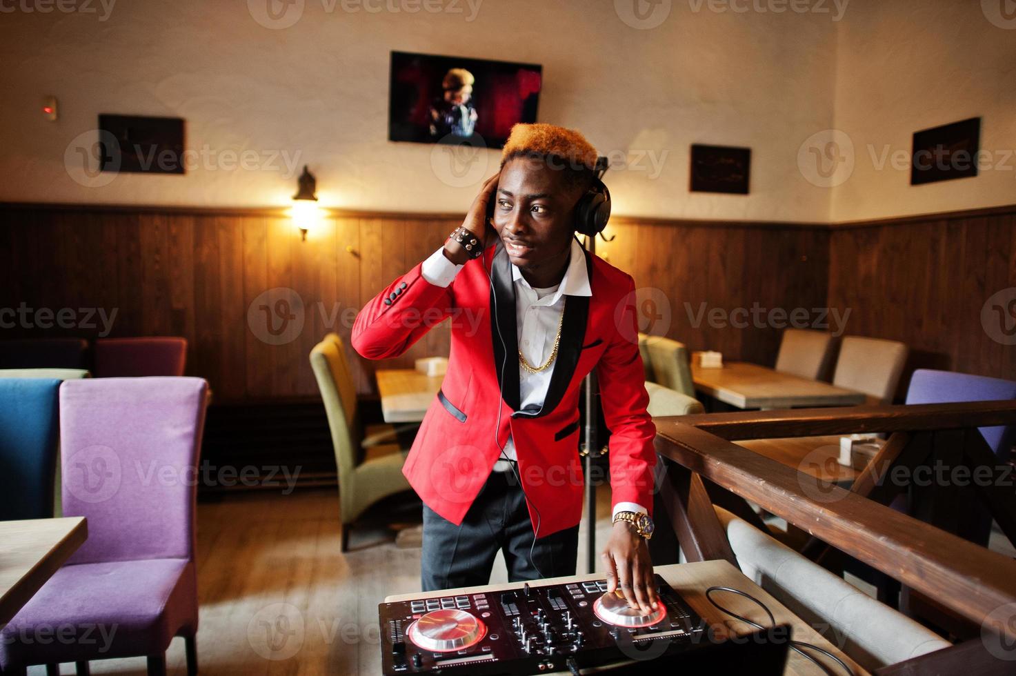 Fashion african american man model DJ at red suit with dj controller. photo