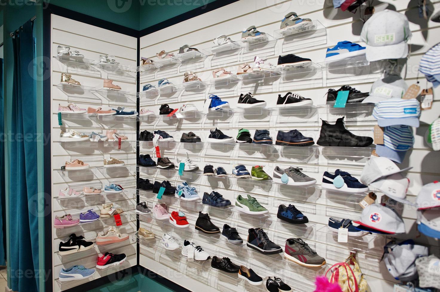 Luxury and fashionable brand new interior of kids shoes and cloth store. photo