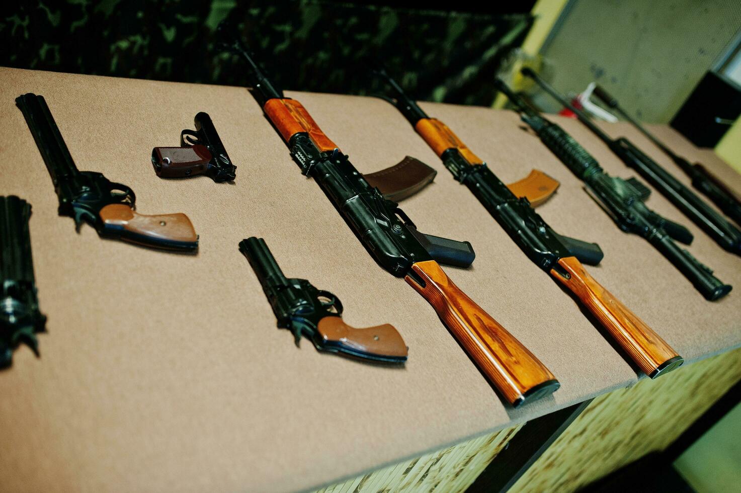 Different machine guns and gun revolvers on shooting range. photo