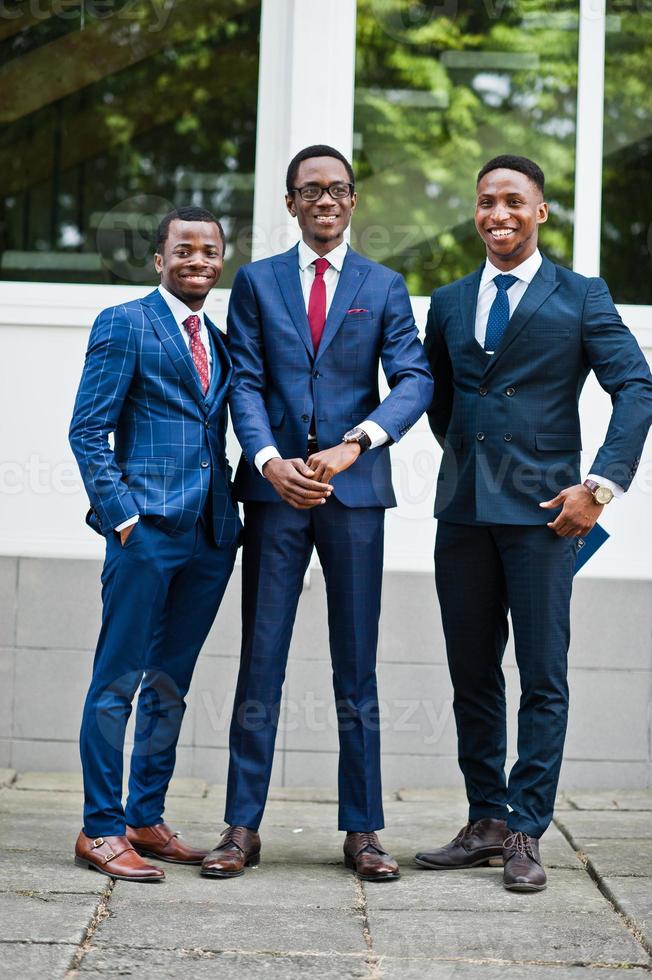 Three african american happy successful mans at suit. photo