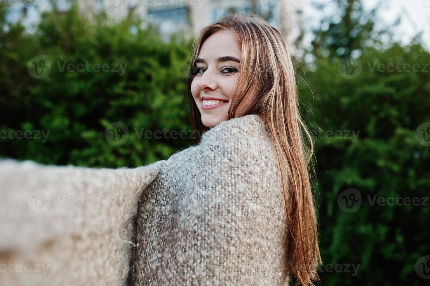 Young brunette girl on plaid having fun at evening spring day. photo