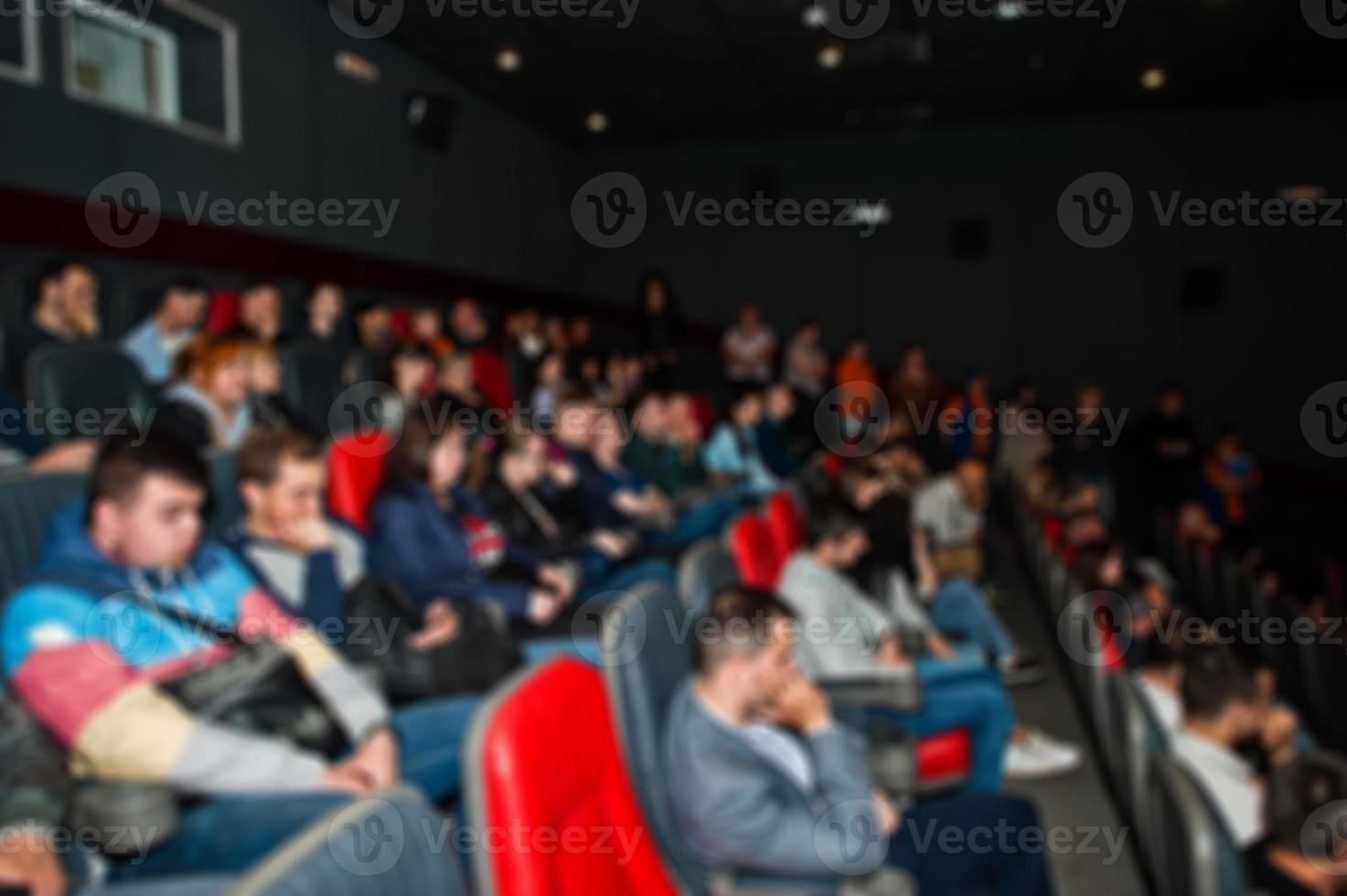 Blured photo of audience peoples in the cinema.