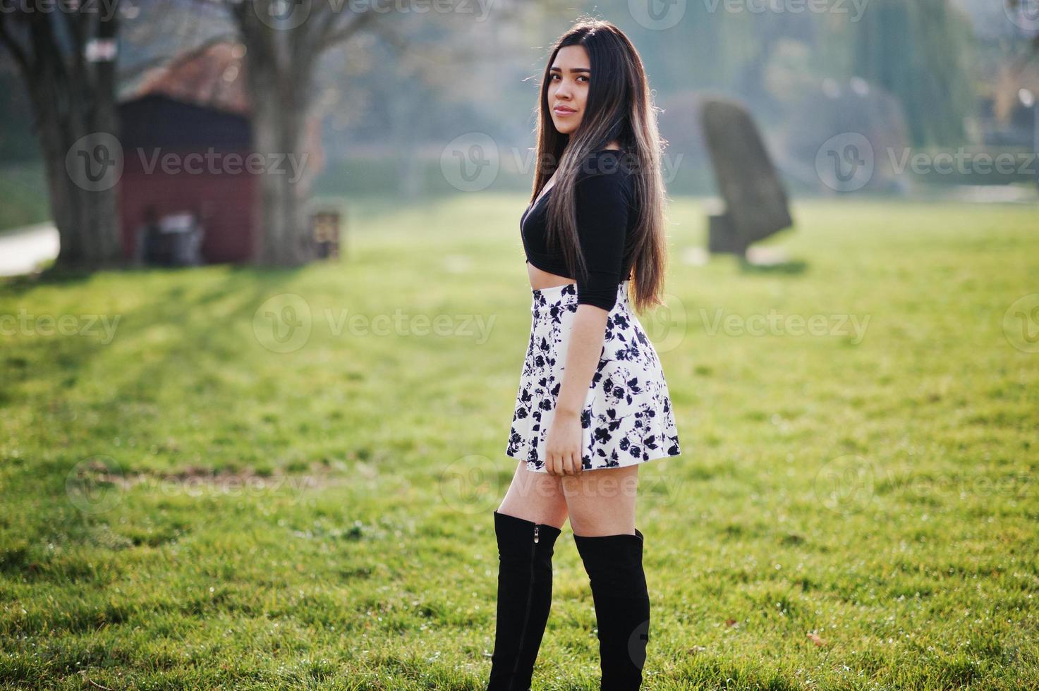 Pretty latino model girl from Ecuador wear on black tops and skirt posed at street. photo