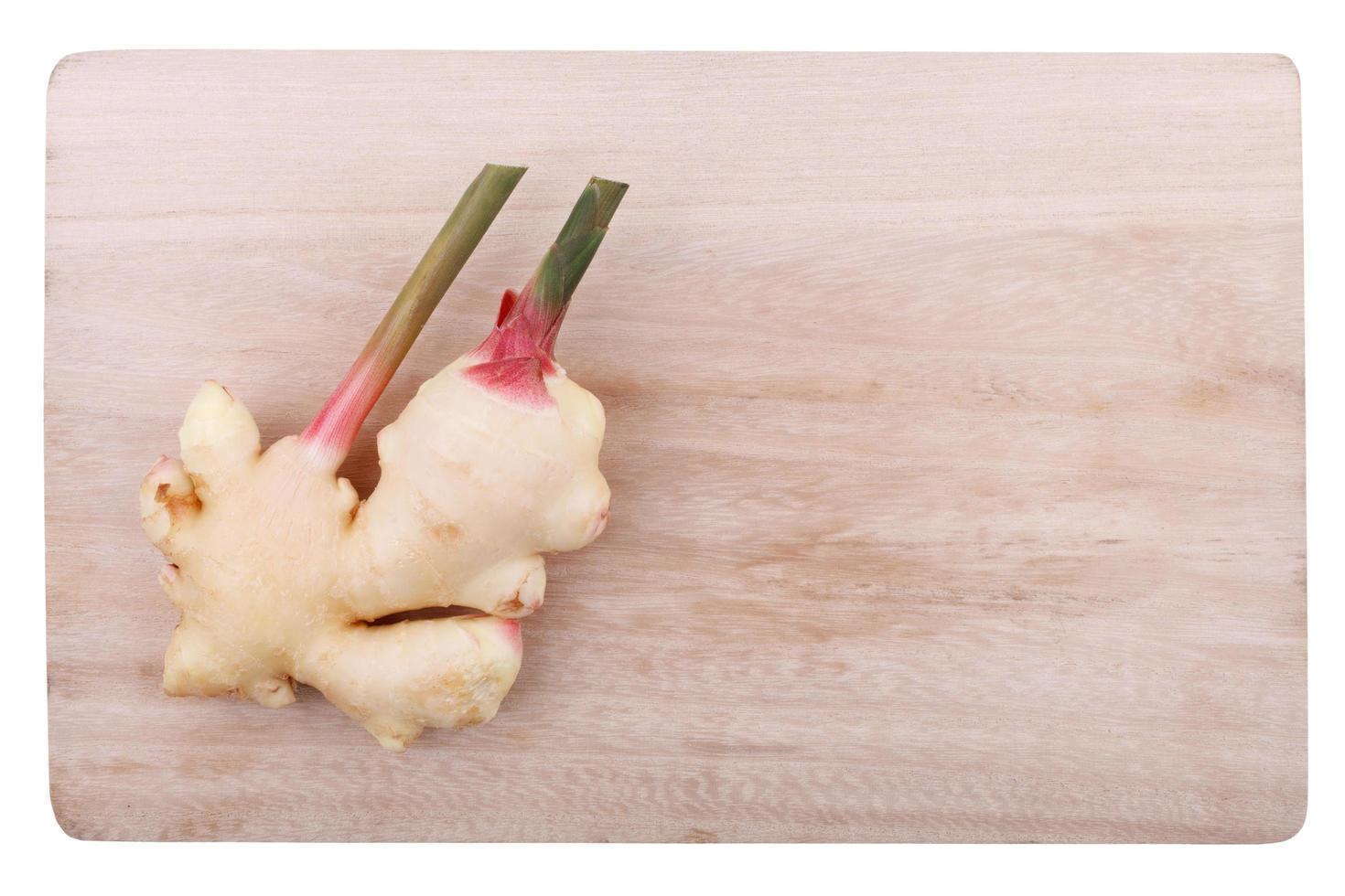 Young gingers on wood cutting board on white background photo