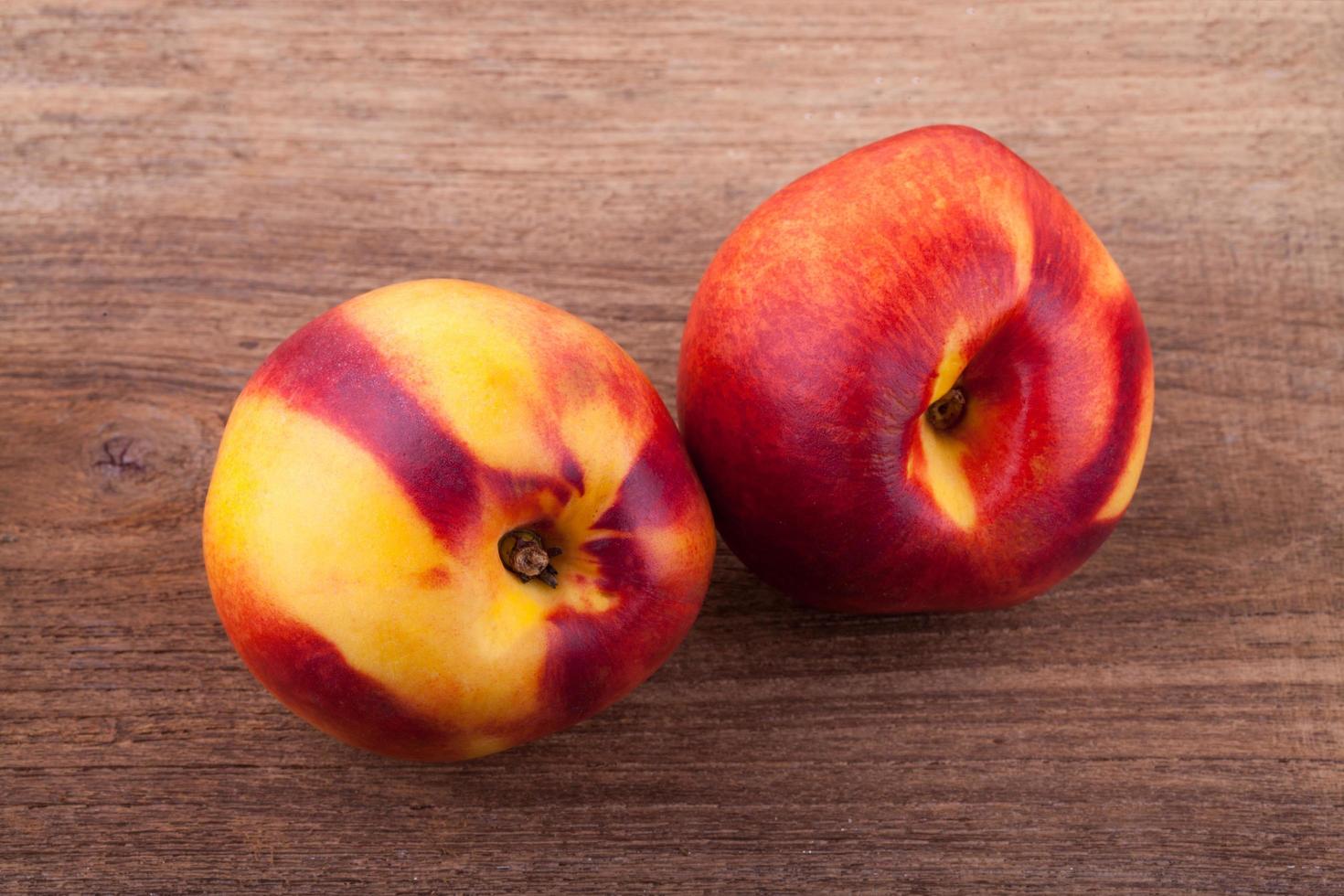 nectarines on wooden table photo