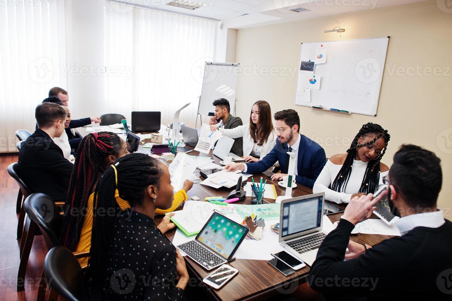 Multiracial young creative people in modern office. Group of young business people are working together with laptop, tablet. Successful freelancers team in coworking. photo