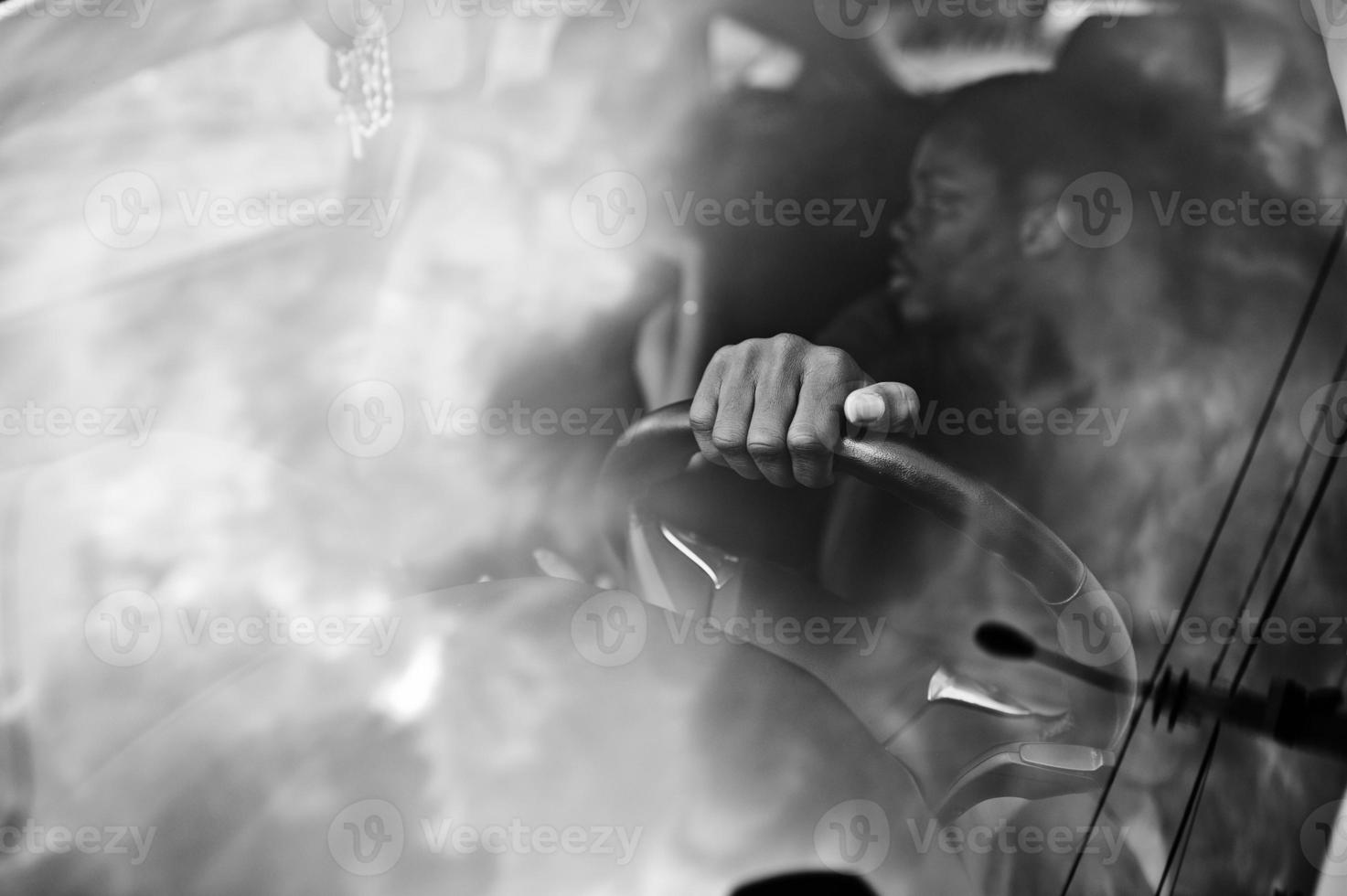 Beautiful young african american couple sitting on the front passenger seats while handsome man driving a car. photo