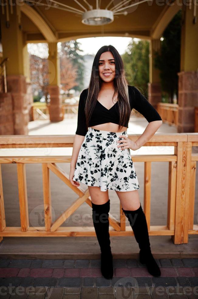 Pretty latino model girl from Ecuador wear on black tops and skirt posed at street. photo