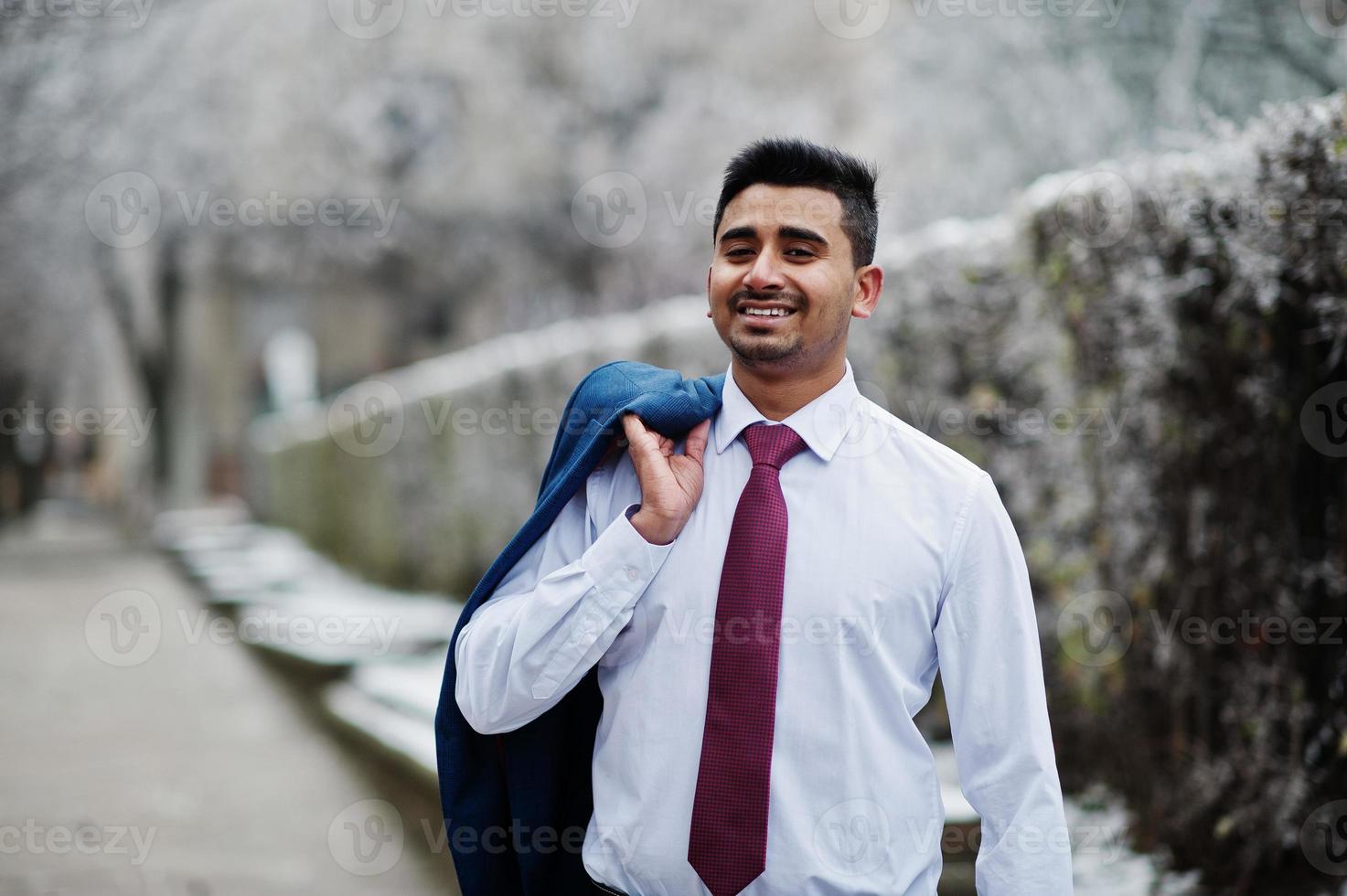 Elegant indian fashionable man model on suit posed at winter day. photo