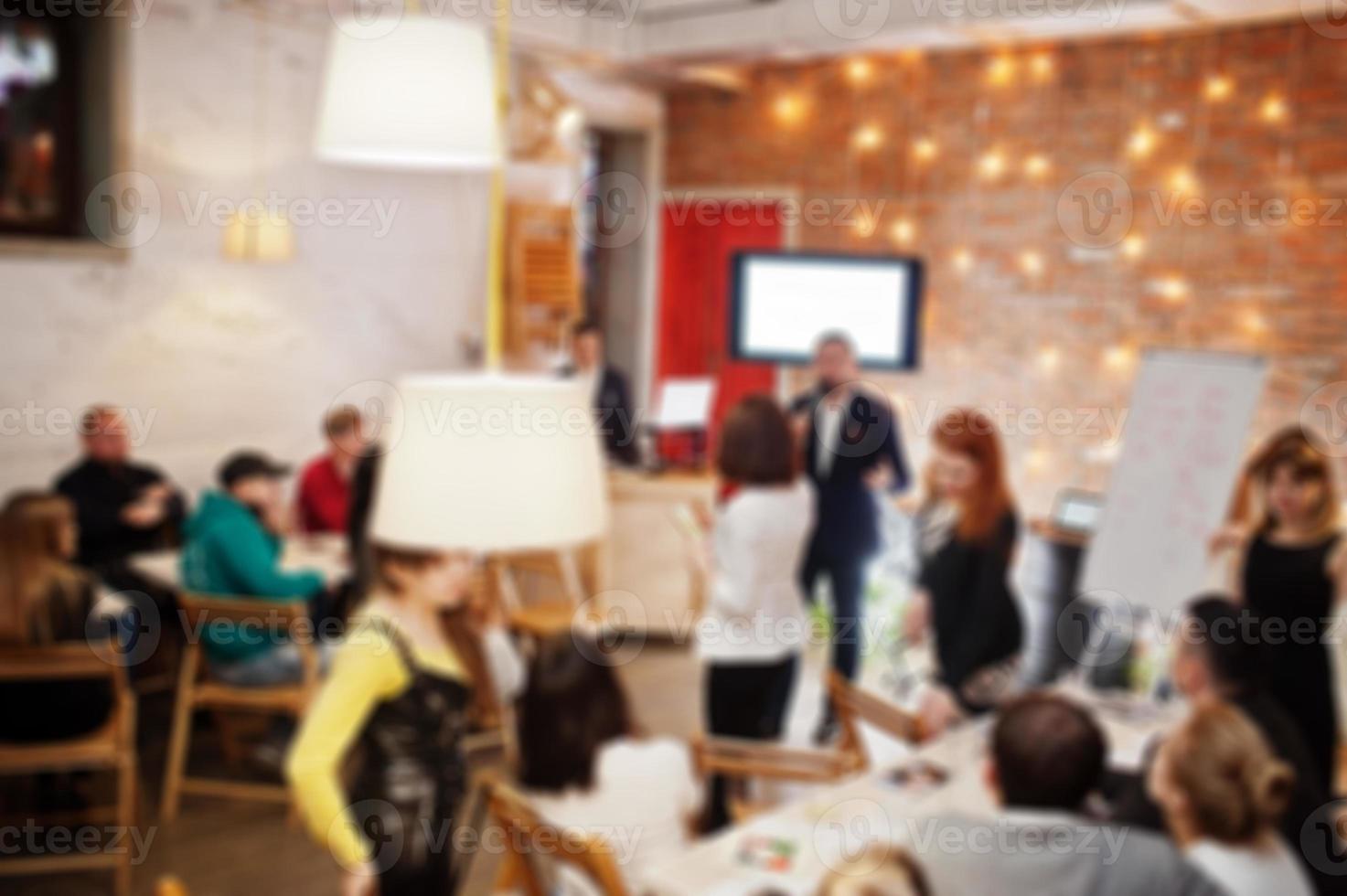 Master class and study concept. Abstract blurred photo of conference or seminar room with speaker on the stage.