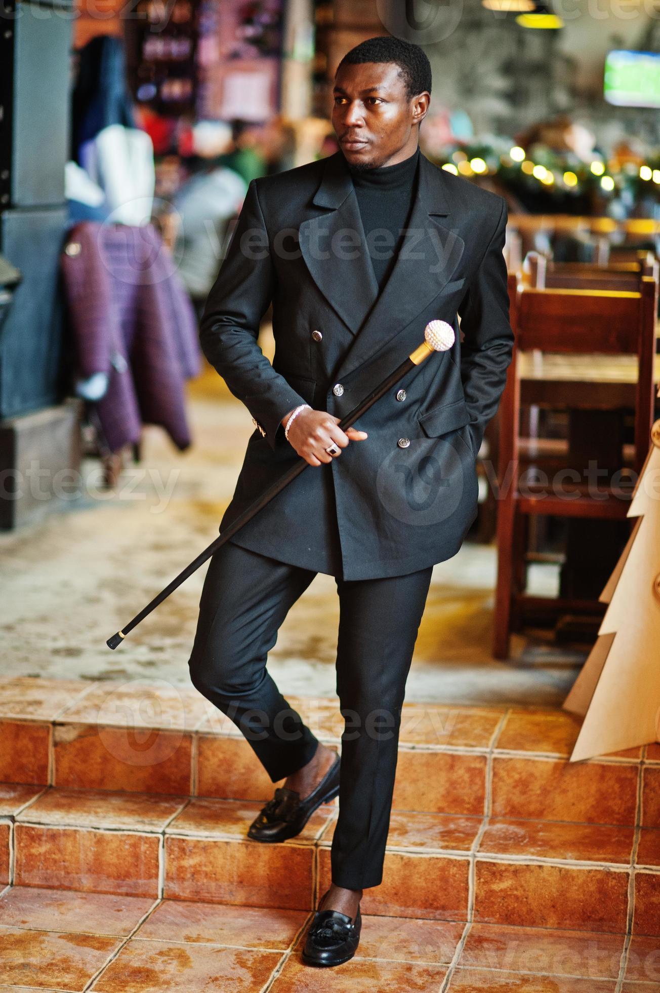 Stylish african american gentleman in elegant black jacket, holding retro  walking stick as cane flask or tippling cane with golden diamond ball  handle. Rich fashionable afro man. 10435078 Stock Photo at Vecteezy