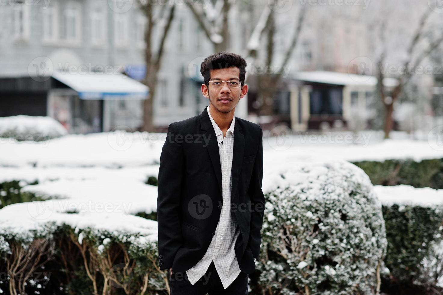 Young indian man on suit posed outdoor in winter day. photo