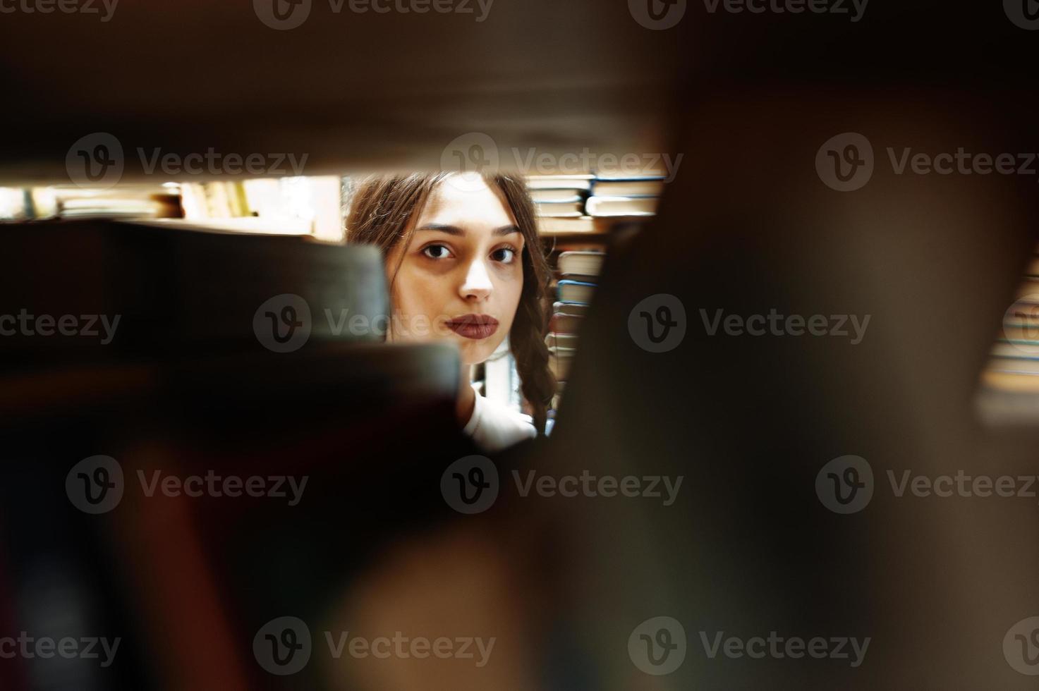 Girl with pigtails in white blouse at old library. photo