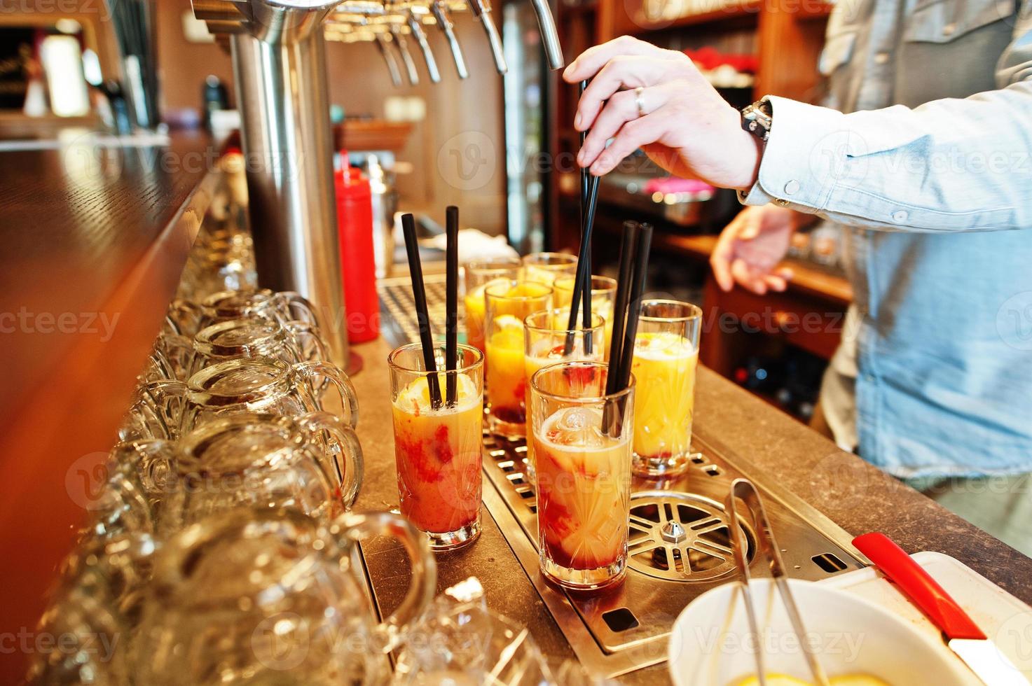 Barman making alcohol cocktail in restaurant. photo