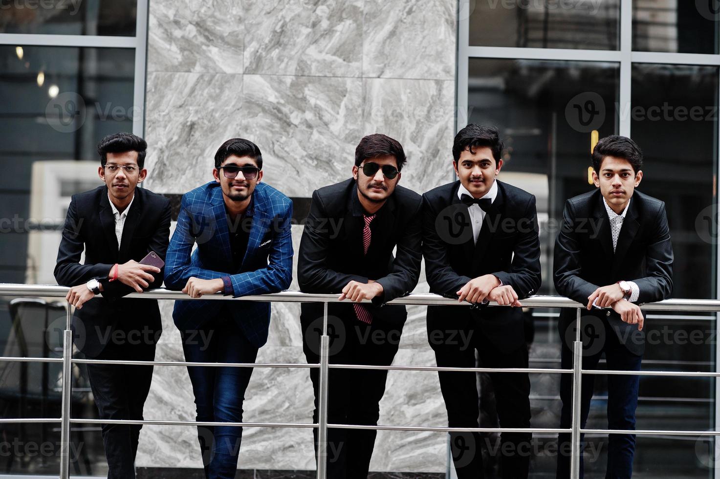 Group of 5 indian students in suits posed outdoor. photo