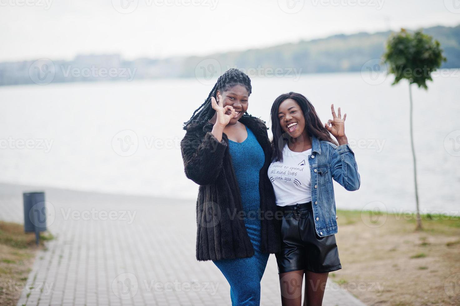 Two african american dark skinned friends female. One of them plus size model, second slim. Having fun and spending time together. photo
