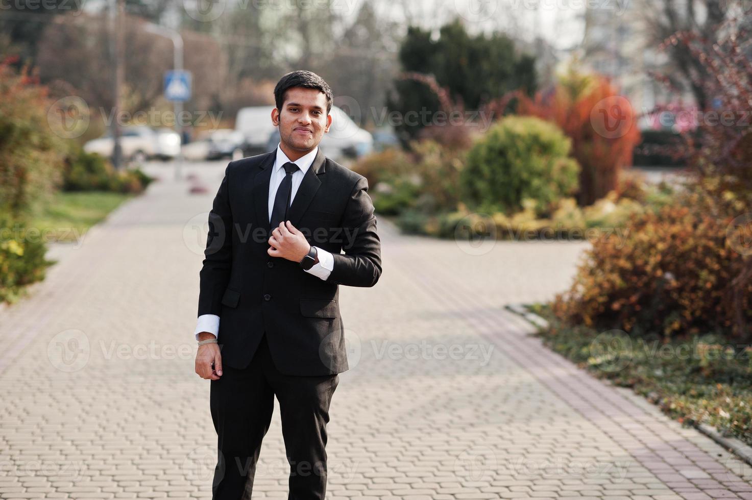 Elegant south asian indian business man in black suit. photo